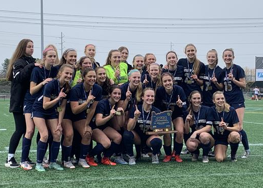 Wilsonville girls soccer poses with the trophy after winning the 5A State Championship.